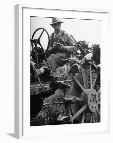 Farmer Sitting on Plow-null-Framed Photographic Print