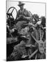 Farmer Sitting on Plow-null-Mounted Photographic Print