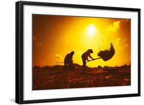 Farmers Silhouettes at Sunset. Rice Grain Threshing during Harvest Time in Northern Thailand-Banana Republic images-Framed Photographic Print