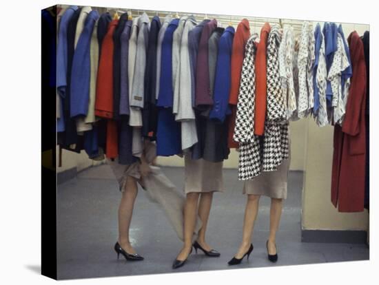 Fashion Models Behind a Suit Rack Trying on Clothes at Zelinka-Matlick, New York, New York, 1960-Walter Sanders-Stretched Canvas