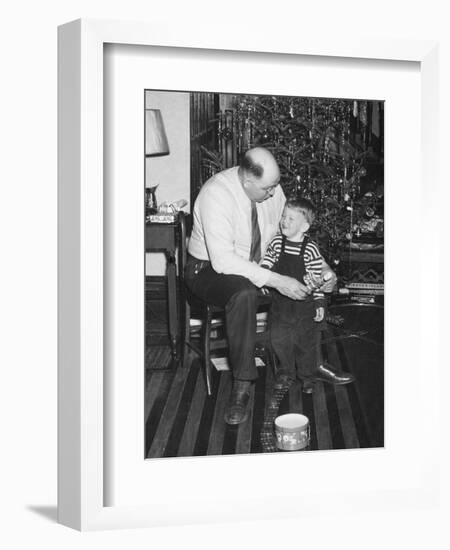 Father and Son Enjoy Christmas Morning, Ca. 1950-null-Framed Photographic Print