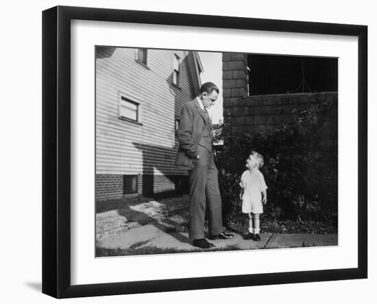 Father and Son Look at Each Other on Sidewalk, Ca. 1930.-Kirn Vintage Stock-Framed Photographic Print