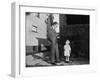 Father and Son Look at Each Other on Sidewalk, Ca. 1930.-Kirn Vintage Stock-Framed Photographic Print