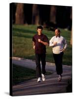 Father and Son Out for a Fitness Run-Paul Sutton-Stretched Canvas