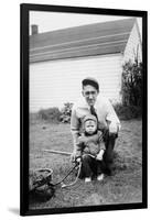 Father and Son Pull a Wagon in Backyard, Ca. 1946-null-Framed Photographic Print