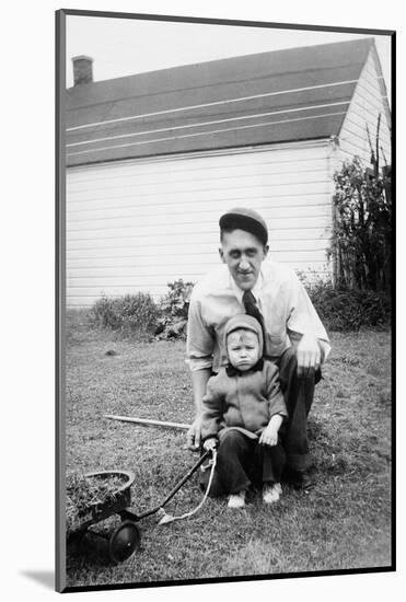 Father and Son Pull a Wagon in Backyard, Ca. 1946-null-Mounted Photographic Print