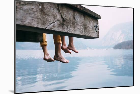 Father and Son Swung their Legs from the Wooden Pier on Mountain Lake-Soloviova Liudmyla-Mounted Photographic Print