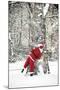 Father Christmas in Snow Behind Tree-null-Mounted Photographic Print