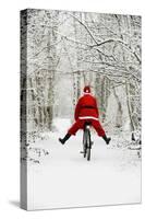 Father Christmas Riding Bicycle in Snowy Woodland Path-null-Stretched Canvas