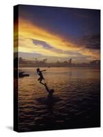 Father Playfully Throwing Son in Water-Barry Winiker-Stretched Canvas