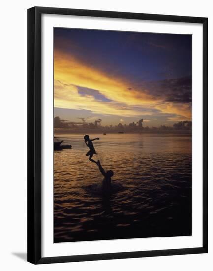 Father Playfully Throwing Son in Water-Barry Winiker-Framed Premium Photographic Print