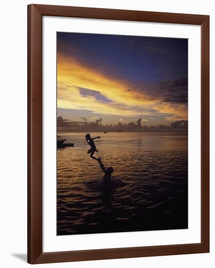 Father Playfully Throwing Son in Water-Barry Winiker-Framed Photographic Print