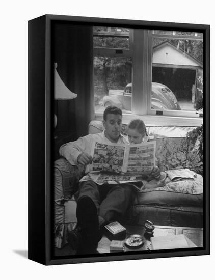 Father Sitting on Couch with Pigtailled Daughter Reading to Her the Sunday Comic Pages-Nina Leen-Framed Stretched Canvas