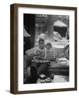 Father Sitting on Couch with Pigtailled Daughter Reading to Her the Sunday Comic Pages-Nina Leen-Framed Photographic Print