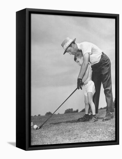 Father Teaching His Small Son How to Play Golf-null-Framed Stretched Canvas