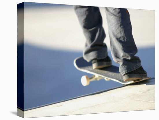 Feet on a Skateboard at the Edge of a Ramp-null-Stretched Canvas