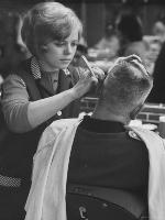 'Female Barber Cutting a Customer's Hair in a Barber Shop' Photographic ...