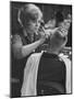 Female Barber Cutting a Customer's Hair in a Barber Shop-Ralph Crane-Mounted Photographic Print