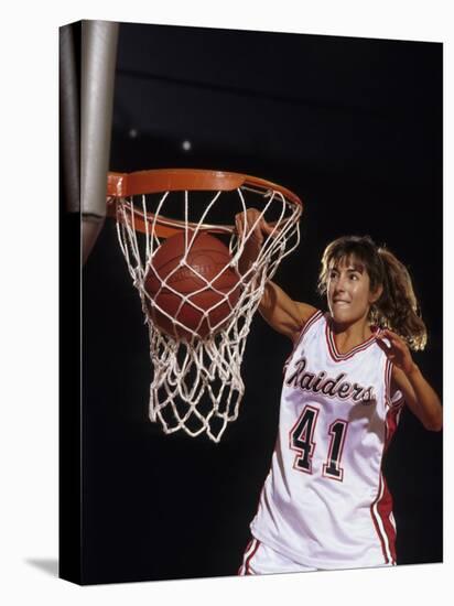 Female Basketball Player Dunking a Ball Through the Hoop-null-Stretched Canvas