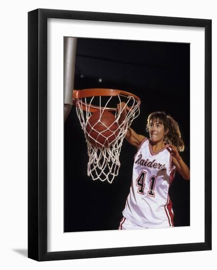 Female Basketball Player Dunking a Ball Through the Hoop-null-Framed Photographic Print