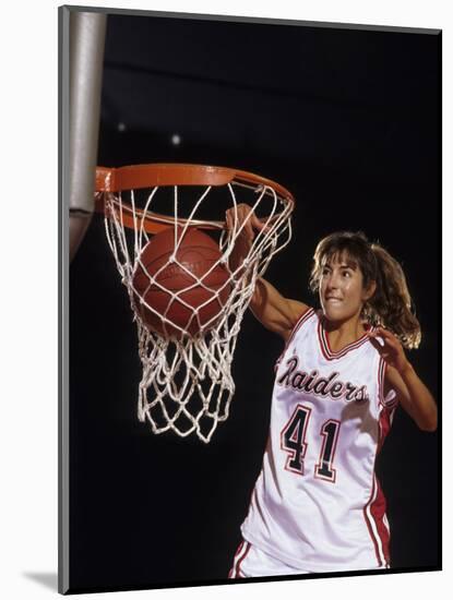 Female Basketball Player Dunking a Ball Through the Hoop-null-Mounted Photographic Print