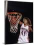 Female Basketball Player Dunking a Ball Through the Hoop-null-Mounted Photographic Print
