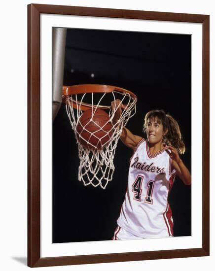 Female Basketball Player Dunking a Ball Through the Hoop-null-Framed Photographic Print