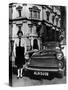 Female Chauffeur Standing by a 1964 Morris Oxford, 1964-null-Stretched Canvas