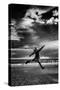 Female Figure Jumping on a Beach-Rory Garforth-Stretched Canvas