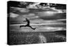 Female Figure Jumping on a Beach-Rory Garforth-Stretched Canvas