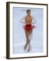 Female Figure Skater Preforming a Spin-null-Framed Photographic Print