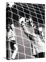 Female Goalie Attempting to Stop a Soccer Ball-null-Stretched Canvas