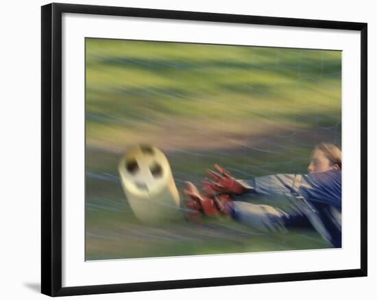 Female Goalie Attempting to Stop a Soccer Ball-null-Framed Photographic Print
