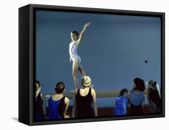 Female Gymnast Performing on a Balance Beam-null-Framed Stretched Canvas