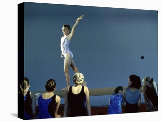 Female Gymnast Performing on a Balance Beam-null-Stretched Canvas