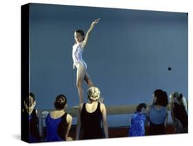 Female Gymnast Performing on a Balance Beam-null-Stretched Canvas