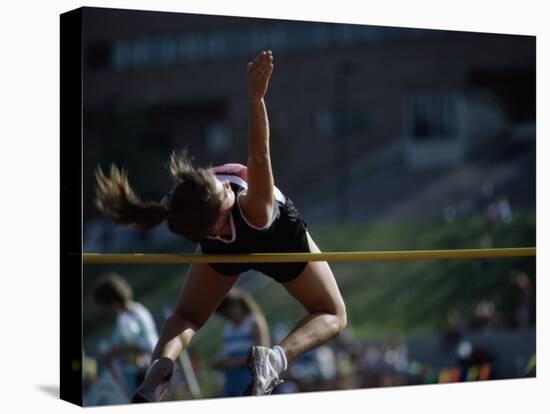 Female High Jumper Clearing a Bar-null-Stretched Canvas