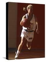 Female High School Basketball Player in Action During a Game-null-Stretched Canvas