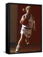 Female High School Basketball Player in Action During a Game-null-Framed Stretched Canvas