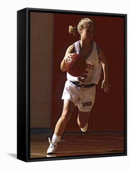 Female High School Basketball Player in Action During a Game-null-Framed Stretched Canvas