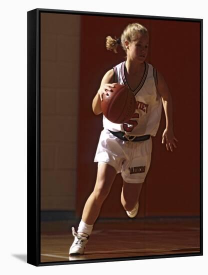 Female High School Basketball Player in Action During a Game-null-Framed Stretched Canvas