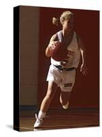 Female High School Basketball Player in Action During a Game-null-Stretched Canvas