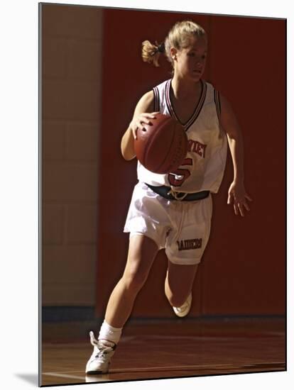Female High School Basketball Player in Action During a Game-null-Mounted Photographic Print