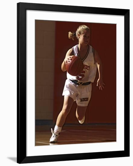 Female High School Basketball Player in Action During a Game-null-Framed Photographic Print