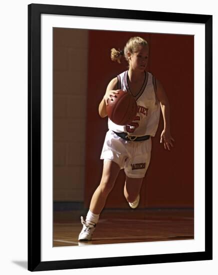 Female High School Basketball Player in Action During a Game-null-Framed Photographic Print