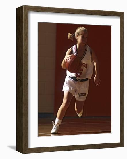 Female High School Basketball Player in Action During a Game-null-Framed Photographic Print