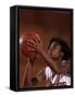 Female High Schooll Basketball Player in Action Shooting a Free Throw During a Game-null-Framed Stretched Canvas