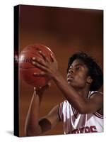 Female High Schooll Basketball Player in Action Shooting a Free Throw During a Game-null-Stretched Canvas