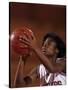 Female High Schooll Basketball Player in Action Shooting a Free Throw During a Game-null-Stretched Canvas