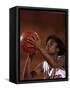 Female High Schooll Basketball Player in Action Shooting a Free Throw During a Game-null-Framed Stretched Canvas
